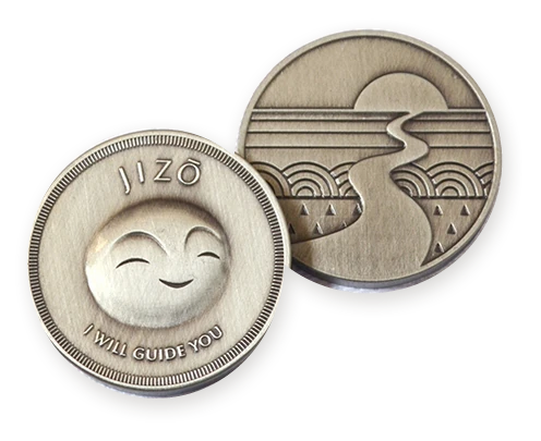 Both sides of the Jizō coin: a smiling face with the words I will guide you, and a path that winds towards the sun.